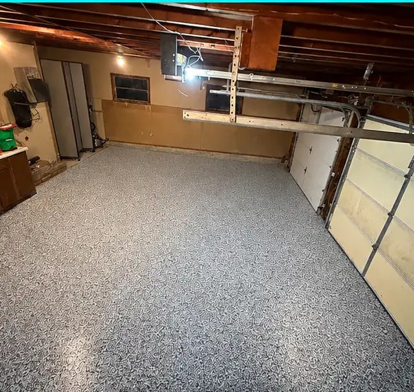 Garage floor after a gray-blue epoxy flake installation